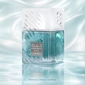 Lattafa Khamrah Waha Lattafa Perfumes 100ml EDP — A clear glass perfume bottle with blue liquid and a textured white cap, set against a rippling light blue water-like background with reflections. | Lattafa Khamrah Waha Lattafa Perfumes 100ml EDP — Botol minyak wangi kaca jernih dengan cecair biru dan penutup putih