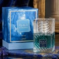 Lattafa Khamrah Waha Lattafa Perfumes 100ml EDP — A square glass perfume bottle with a textured cap and teal liquid sits on a blue marble surface next to its matching blue marble patterned box. | Lattafa Khamrah Waha Lattafa Perfumes 100ml EDP — Botol minyak wangi kaca berbentuk segi empat dengan penutup bertekstur