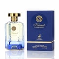 Maison Alhambra Kismet Lunar Magic 100ml — A clear glass perfume bottle with a gold cap and blue gradient base, next to its matching blue and gold box, both featuring gold circular emblems and deer motifs. | Maison Alhambra Kismet Lunar Magic 100ml — Botol minyak wangi kaca jernih dengan penutup emas dan tapak gradien