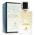 Maison Alhambra Leonie for Women by Maison Alhambra 100ml — A clear glass perfume bottle with a gold and black cap sits next to its white and black patterned box, both featuring gold lettering and a deer silhouette. | Maison Alhambra Leonie for Women by Maison Alhambra 100ml — Botol minyak wangi kaca jernih dengan