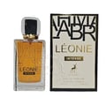 Maison Alhambra Leonie Intense — Clear glass perfume bottle with golden accents and a black cap, next to its beige and black box with gold lettering and a deer illustration. | Maison Alhambra Leonie Intense — Botol minyak wangi kaca jernih dengan aksen emas dan penutup hitam, bersebelahan dengan kotak beige dan