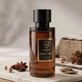 Bujairami Mad Love — Amber glass perfume bottle with black cap, gold label featuring a crown and 'Mad Love' text, set on a marble surface with star anise, copper beads, and wood accents.