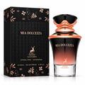 Maison Alhambra Mia Dolcezza — Black and rose gold gradient perfume bottle with ornate cap, next to its matching black box with rose gold floral and geometric patterns.