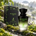 Maison Alhambra Mia Dolcezza Verde EDP Unisex — Black perfume bottle with green gradient and water droplets, next to its matching black box, set on mossy rocks with a blurred waterfall background.