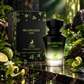 Maison Alhambra Mia Dolcezza Verde — Perfume bottle and box with bergamot, lime zest, and green foliage on a dark reflective surface.