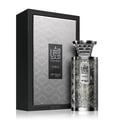 Zimaya Modhesh Noble 100ml — A silver patterned box stands next to a matching silver patterned perfume bottle, both with Arabic script and text. | Zimaya Modhesh Noble 100ml — Kotak corak perak berdiri di sebelah botol minyak wangi corak sepadan, kedua-duanya dengan skrip Arab dan teks.