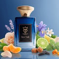 Bujairami New York Eau de Parfum 100ml — Blue gradient glass bottle with gold cap, surrounded by rose, lavender, iris, citrus slices, and caramel candies.