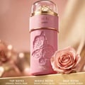 Zimaya Ode to Rose Royale Eau De Parfum 100ml by Zimaya — A pink perfume bottle with embossed roses and gold accents, next to a real pink rose on a golden surface. | Zimaya Ode to Rose Royale Eau De Parfum 100ml by Zimaya — Botol minyak wangi merah jambu dengan bunga ros timbul dan aksen emas, bersebelahan mawar merah