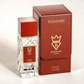 Bujairami Oud Money by Bujairami 100ml Extrait — Clear faceted glass perfume bottle with a red wooden cap and a red label, next to its brown leather presentation box with gold embossed logo.