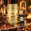 Lattafa Oud Mood 30ml EDP Unisex — Tall gold-accented cream cylinder packaging with ornate patterns, a clear glass perfume bottle with black ribbon accents, oud wood sticks, and amber resin pieces on a marble surface, with soft candlelit lanterns in the background.