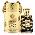 Lattafa Oud Mood 30ml EDP Unisex — Gold ornate cylindrical box with rope handles next to a clear glass perfume bottle with black ribbon wrap and gold cap, on a white background.