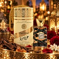 Lattafa Oud Mood 30ml EDP Unisex — A Lattafa Oud Mood perfume bottle and its cylindrical packaging, adorned with gold accents and Arabic calligraphy, sit on a golden tray with oud wood chips, amber resin, and red roses.