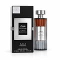 Ard Al Zaafaran Oud Romancea Fakhama — Black box with intricate silver pattern next to a clear glass perfume bottle with ribbed sides and a silver cap, showing amber liquid.