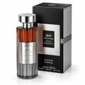 Ard Al Zaafaran Oud Romancea Fakhama — Amber liquid perfume bottle with silver ribbed base and metallic cap, next to a black and silver ribbed box with textured silver panel.
