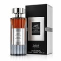 Ard Al Zaafaran Oud Romancea Fakhama — Amber liquid perfume bottle with fluted silver base and metallic cap, next to a black and silver textured box.
