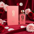 Afnan 9 AM – Pour Femme by Afnan Perfumes – 100 ml for Women, featuring a pink box and glass bottle with gold accents, surrounded by red velvet and pink and red roses.