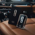 Afnan 9PM by Afnan 100ml EDP Men — Black box and glass bottle with black cap on brown leather car seat