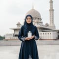 Afnan Pure Musk — Woman in hijab holds perfume bottle in front of a mosque