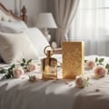 Afnan Supremacy Gold — Gold perfume bottle and box on a white bed with pink roses and petals