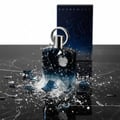 Afnan Supremacy Incense — A shattered glass perfume bottle with liquid splashing on a dark marble surface, with its box in