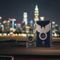 Al Wataniah Eqaab by Al Wataniah Elite 100 ml for Men — Perfume bottle and box on car dashboard with city skyline at night