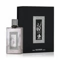 Al Wataniah Kayaan Classic by Al Wataniah Homme Intense 100ml For Man — Botol wangian kaca kelabu berkilat dengan penutup perak bertekstur, diletakkan di sebelah kotak hitam bertekstur dengan reka bentuk perak.