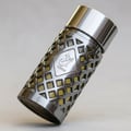 Ard Al Zaafaran Jazzab Silver – A metallic grey perfume bottle with a geometric lattice design and yellow liquid, angled on