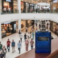 Ard Al Zaafaran Desert Sultan Sapphire — Blue textured perfume bottle with silver cap sits on a wooden railing in a mall.
