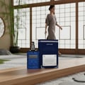 Ard Al Zaafaran Desert Sultan Sapphire — Blue textured perfume bottle and box on a wooden surface with bamboo and a woman