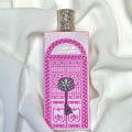 Ard Al Zaafaran Bab Al Wardi — Pink perfume bottle with ornate silver key and Arabic script on a white draped fabric