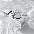 Armaf Club De Nuit Sillage — Silver bottle with black geometric pattern submerged in rippling water