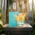 Armaf Odyssey Aqua Edition — Perfume bottle and box with citrus fruit splashes and greenery inside a train