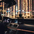 Armaf Club De Nuit Urban Elixir — Black perfume bottle on a car dashboard at night with bokeh city lights
