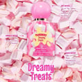 Grandeur Dreamy Treats Tubbees For Her 50ml — Pink perfume bottle with white and pink swirls, surrounded by marshmallows. Notes listed: Top (Lily of the Valley, Peach, Coconut, Sandalwood), Middle (Rice, White Flowers, Caramel), Base (Milk, Musk, Sandalwood, Tonka).