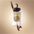 Gulf Orchid Musk Tahara Vanilla 60ml Gulf Orchid Woman — A clear glass perfume bottle with a black cap, featuring a gold mandala design and text. Two dried vanilla pods are positioned behind and in front of the bottle.