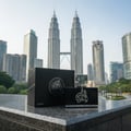 Lattafa Al Dur Al Maknoon Silver 100ml EDP Men — Black perfume box and bottle with Arabic calligraphy against Kuala Lumpur