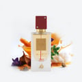 Lattafa Ana Abiyedh Rouge — Perfume bottle with red cap, surrounded by spices, pine sprigs, and a purple flower.