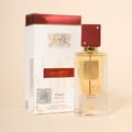 Lattafa Ana Abiyedh Rouge — White box with gold accents and red top next to a clear glass perfume bottle with red cap and
