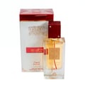 Lattafa Ana Abiyedh Rouge — White box with gold accents and red lid next to a clear glass perfume bottle with red cap and