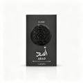 Lattafa Asad Elixir — Kotak hitam legam dengan lambang singa timbul di tengah dan tulisan 'ELIXIR' di atasnya, serta tulisan Arab dan 'ASAD' di bawahnya.