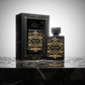 Lattafa Badee Al Oud by Lattafa Oud for Glory — Black perfume box with gold accents and a bottle, set on a wet marble