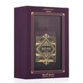 Lattafa Badee Al Oud Amethyst — Purple box with gold geometric design and clear window revealing gold bottle label.