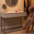 Lattafa Charm 100ml EDP for Women by LaMuse Lattafa — Woman in hijab putting on high heels by a vanity table with perfume