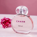 Lattafa Charm 100ml EDP for Women by LaMuse Lattafa — Pink perfume bottle with clear cap, next to a pink rose on a pink