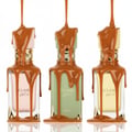 Lattafa Eclaire Banoffi — Three perfume bottles with caramel dripping over them, one pink, one green, one yellow.