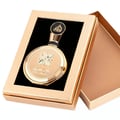 Lattafa Fakhar Extrait — Gold ornate perfume bottle in an open gold gift box with black insert