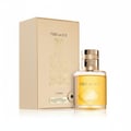Lattafa Fire On Ice by Lattafa 100ml EDP Unisex — Botol kaca berisi cecair keemasan dengan penutup emas, diletakkan di sebelah kotak kadbod berwarna krim dengan reka bentuk berukir.