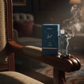 Lattafa Hayaati Al Maleky by Lattafa – 100 ml for Men, a blue box and clear glass bottle with gold accents, placed on a wooden chair armrest with smoke rising.