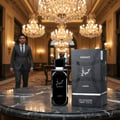 Lattafa Hayaati Men by Lattafa Perfumes 100ml EDP — A man in a grey suit walks past a bottle of Hayaati perfume and its box, set on a marble table in a grand hall with chandeliers.