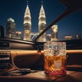 Lattafa Khamrah Dukhan — Botol minyak wangi kaca segi empat dengan cecair perang dan tapak gradien merah jambu, diletakkan di konsol tengah kereta dengan latar belakang langit Kuala Lumpur pada waktu malam.